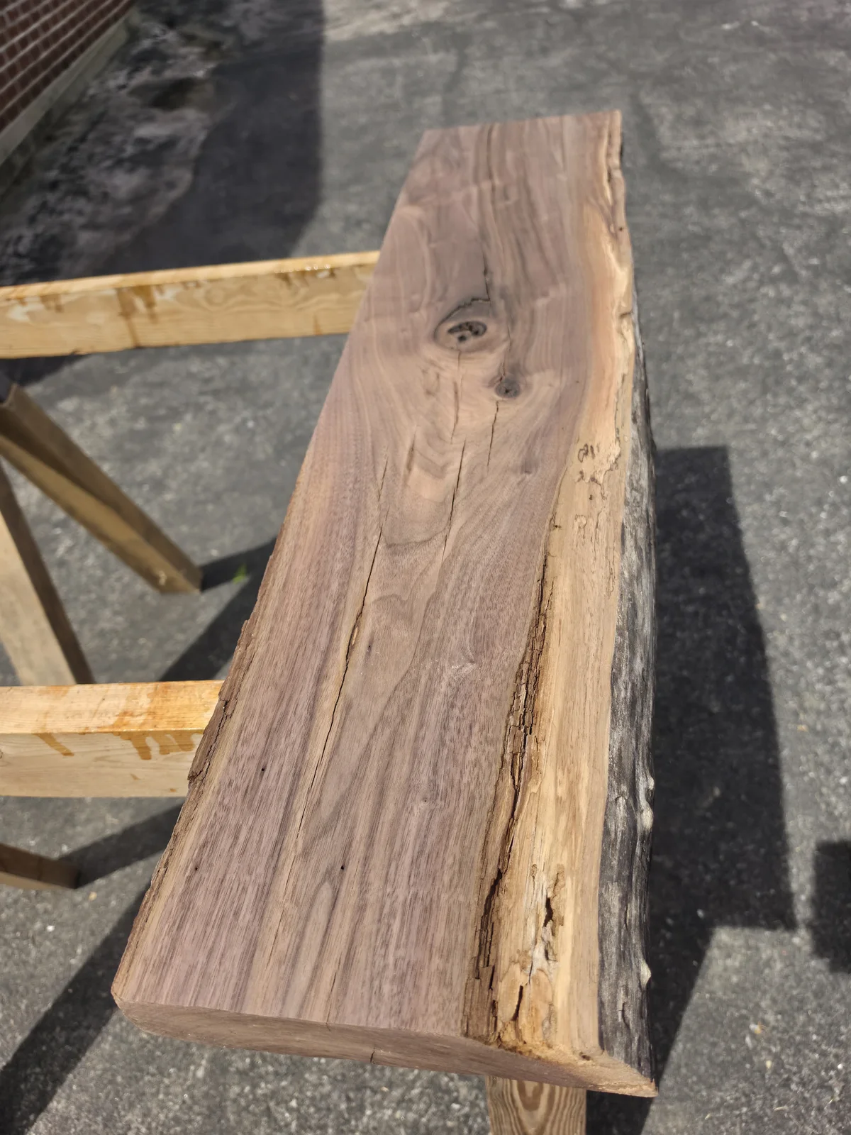 Red walnut slab process image showing reclaimed material development.
